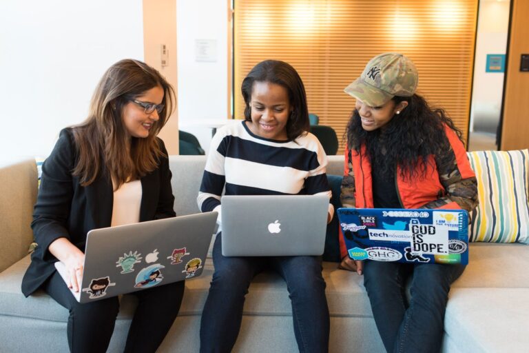 Women looking at laptops