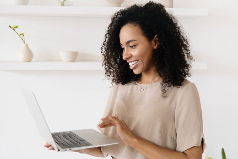 Woman smiling at laptop