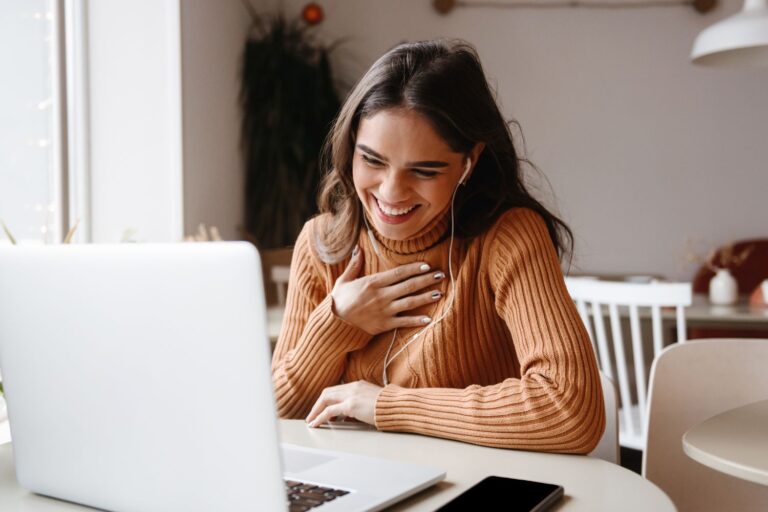 Woman smiling at laptop