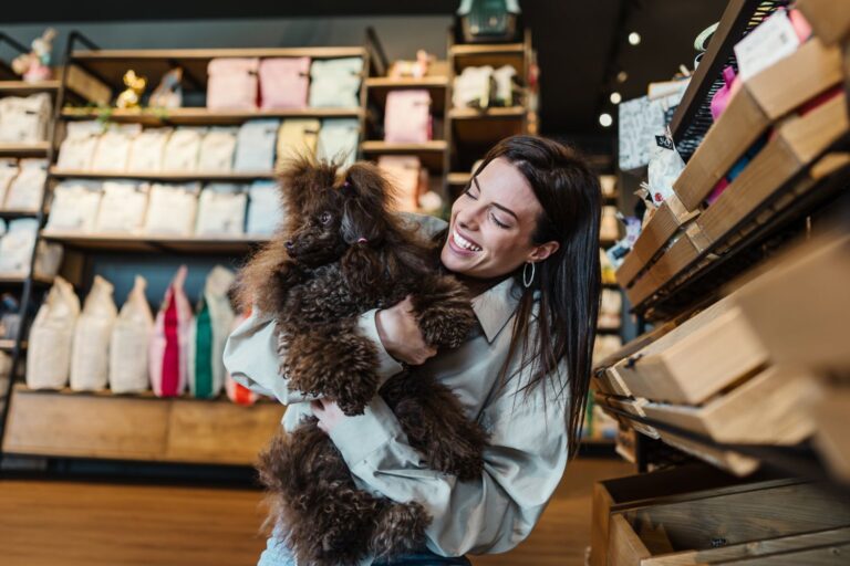 Woman hugging dog in pet store